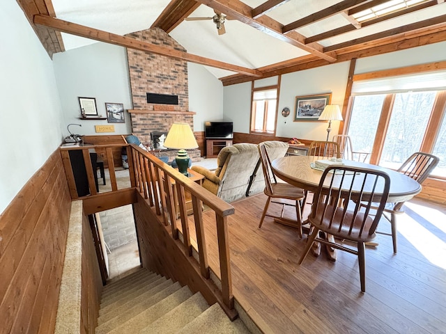 dining area with plenty of natural light, a fireplace, and wood finished floors