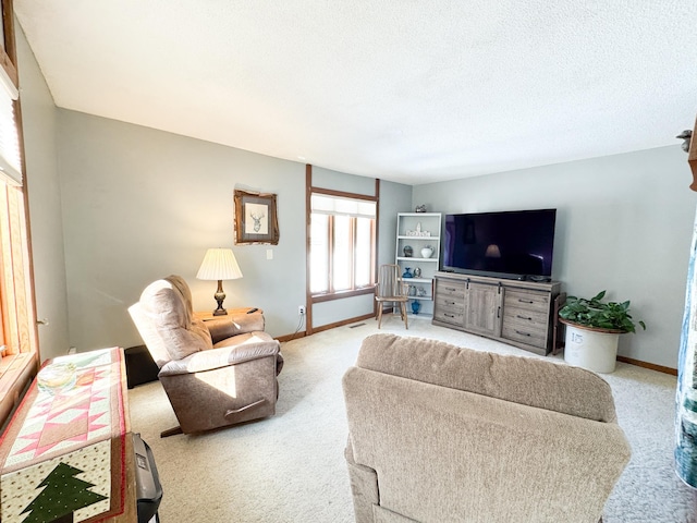 carpeted living area featuring visible vents, a textured ceiling, and baseboards