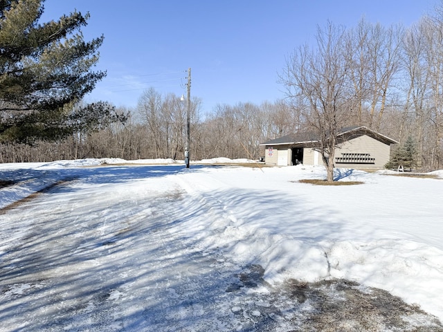 yard layered in snow featuring a garage