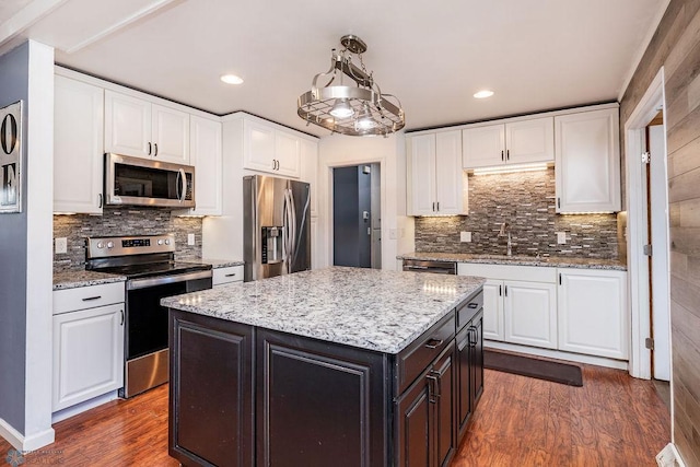 kitchen featuring white cabinetry, sink, a center island, and appliances with stainless steel finishes