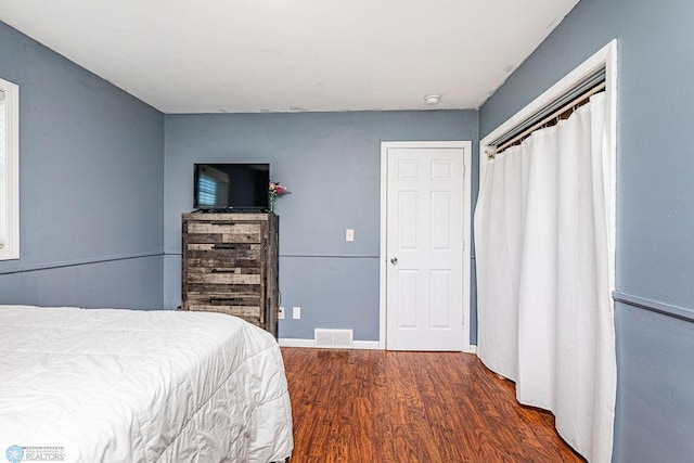 bedroom featuring dark hardwood / wood-style flooring