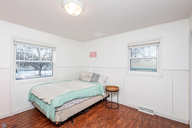 bedroom with dark wood-type flooring