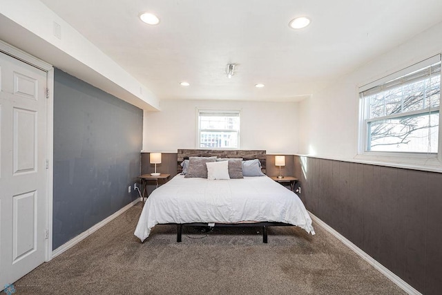 bedroom with wooden walls and carpet floors