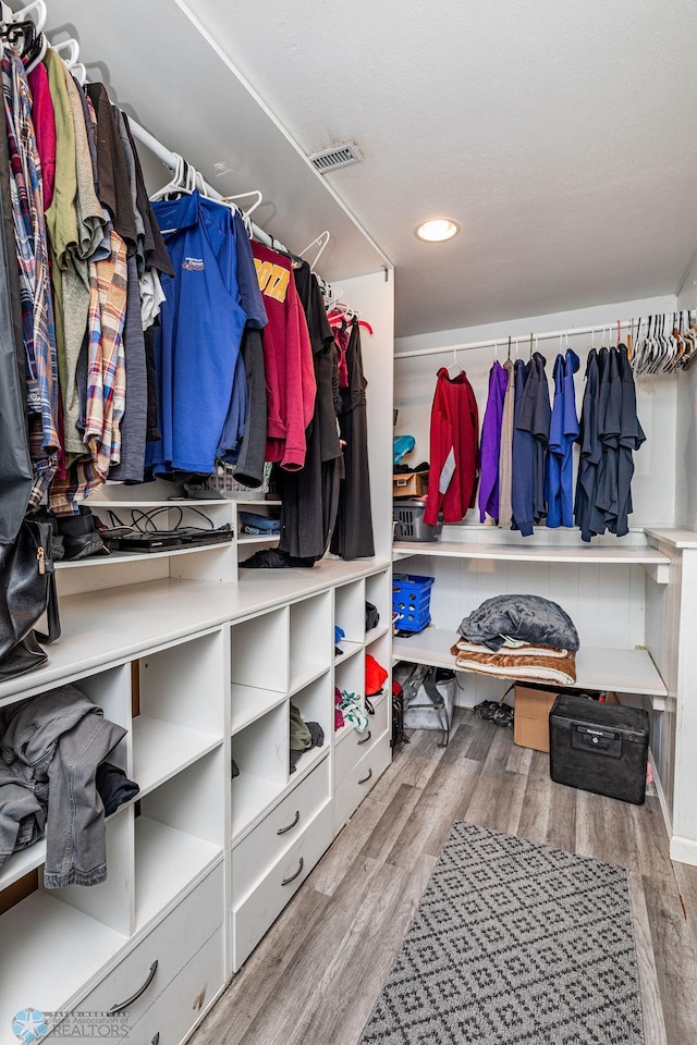 spacious closet with light hardwood / wood-style floors