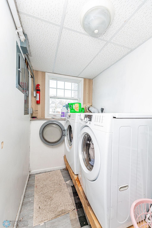 washroom with washing machine and dryer and wood-type flooring