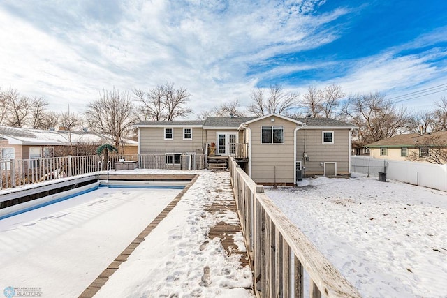 snow covered house with cooling unit