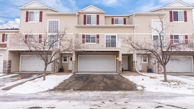 multi unit property featuring a garage and central AC