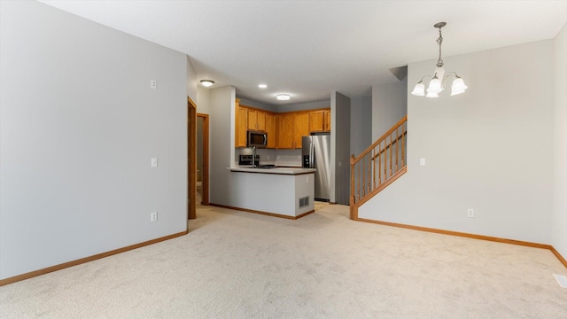 unfurnished living room featuring light colored carpet and a notable chandelier