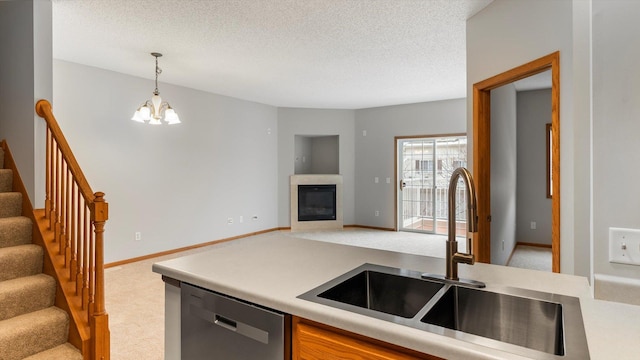 kitchen featuring dishwasher, carpet, sink, and pendant lighting