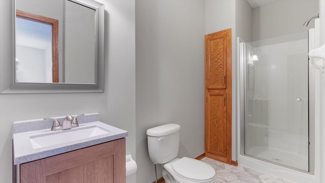 bathroom featuring vanity, toilet, and a shower with shower door