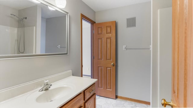 bathroom featuring tile patterned flooring, vanity, a textured ceiling, and walk in shower