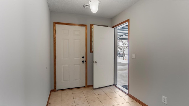 tiled foyer featuring a textured ceiling