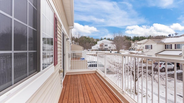 view of snow covered back of property