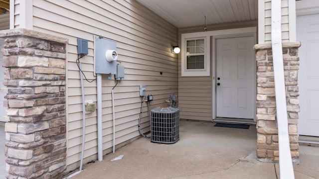 view of exterior entry with central air condition unit