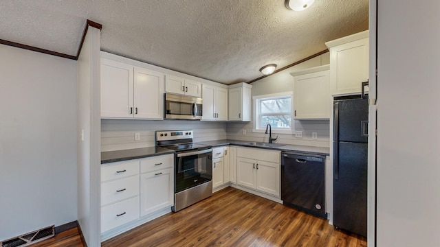 kitchen with sink, white cabinetry, dark hardwood / wood-style floors, black appliances, and a textured ceiling