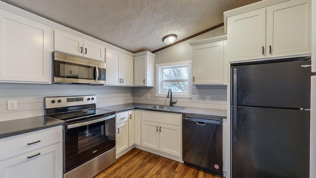 kitchen featuring sink, black appliances, vaulted ceiling, dark hardwood / wood-style floors, and white cabinets