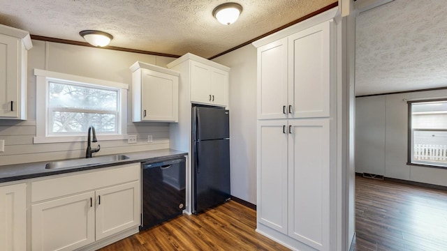 kitchen featuring white cabinetry, sink, dark hardwood / wood-style flooring, decorative backsplash, and black appliances