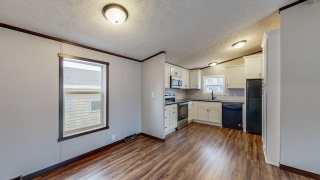 kitchen featuring black appliances, white cabinets, dark hardwood / wood-style flooring, decorative backsplash, and vaulted ceiling