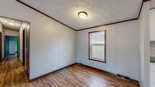 unfurnished room featuring dark hardwood / wood-style flooring and a textured ceiling