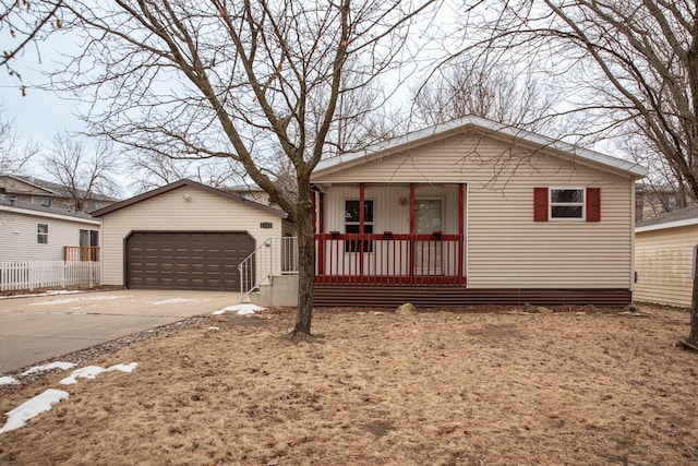 view of front facade with an outbuilding, a garage, and a porch