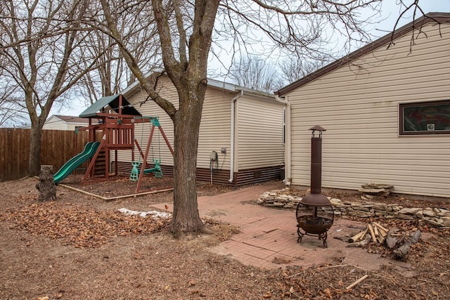 exterior space with an outdoor fire pit and a playground