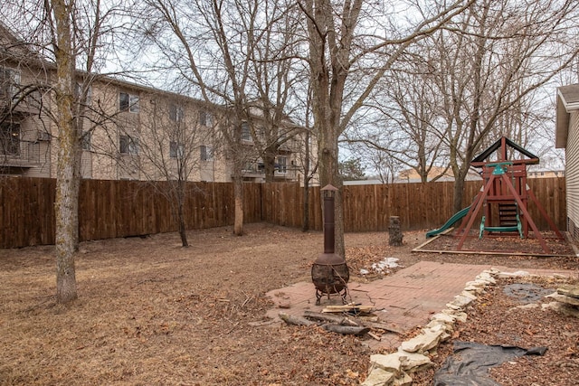 view of yard with a playground and a fire pit