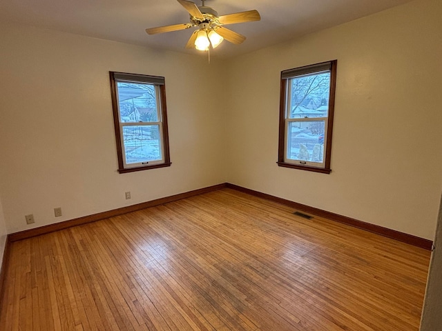 empty room featuring ceiling fan and light hardwood / wood-style flooring