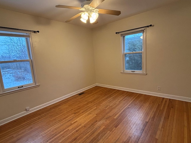 unfurnished room featuring hardwood / wood-style flooring and ceiling fan