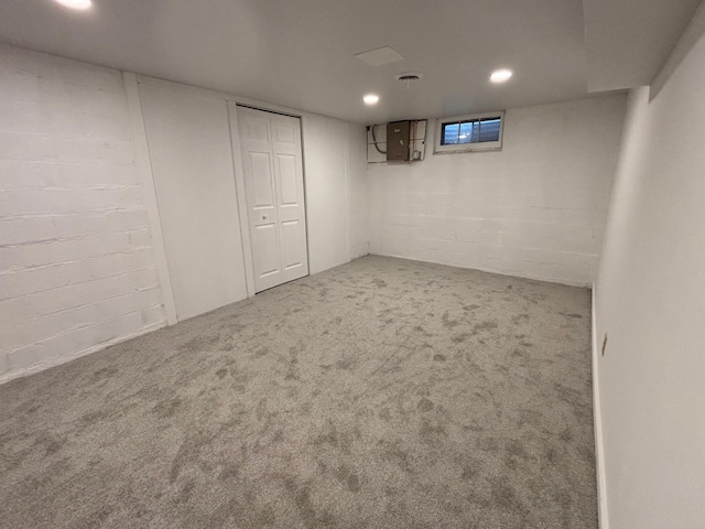 basement featuring electric panel and carpet floors