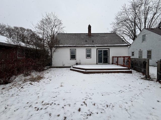 snow covered property featuring a wooden deck