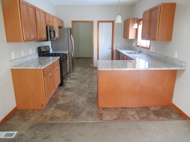 kitchen featuring sink, black gas range, dark colored carpet, decorative light fixtures, and kitchen peninsula