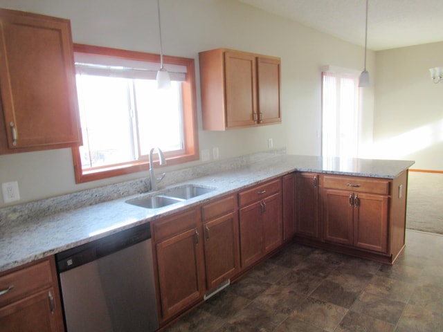 kitchen with a wealth of natural light, decorative light fixtures, sink, stainless steel dishwasher, and kitchen peninsula