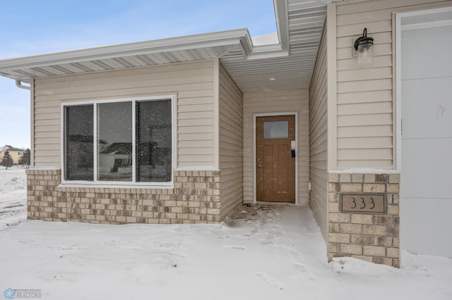 view of snow covered property entrance