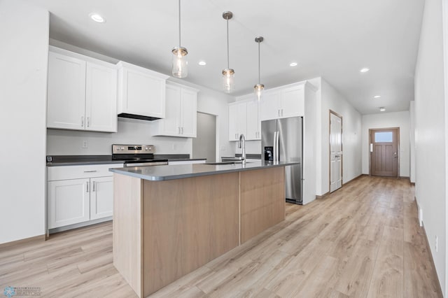 kitchen with sink, white cabinetry, hanging light fixtures, an island with sink, and stainless steel appliances