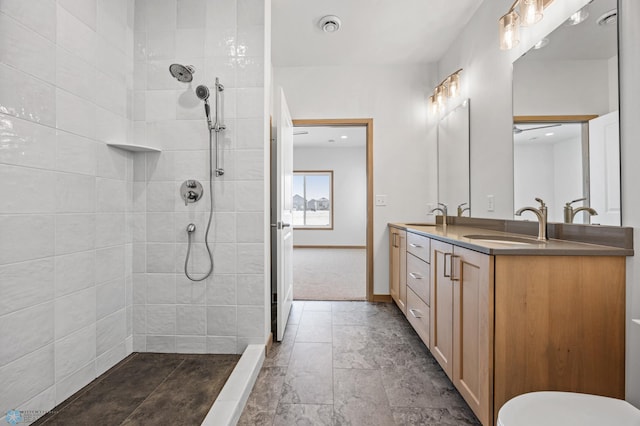 bathroom featuring vanity and tiled shower