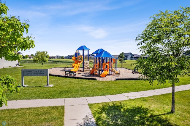 view of playground with a lawn