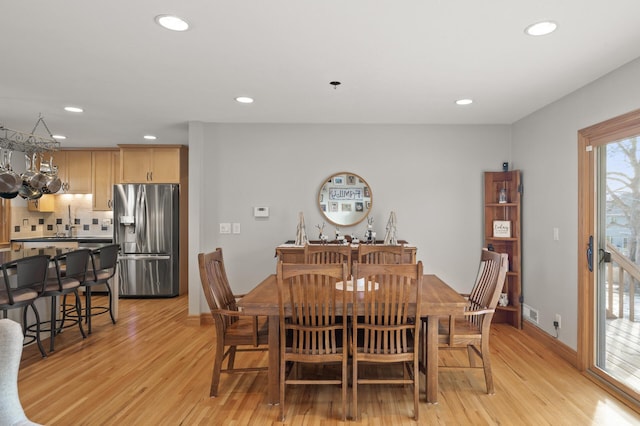 dining area with light wood-type flooring