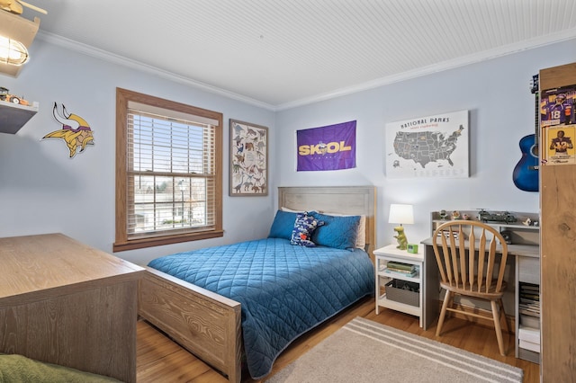 bedroom featuring ornamental molding and hardwood / wood-style floors