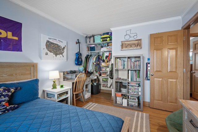 bedroom featuring crown molding and wood-type flooring