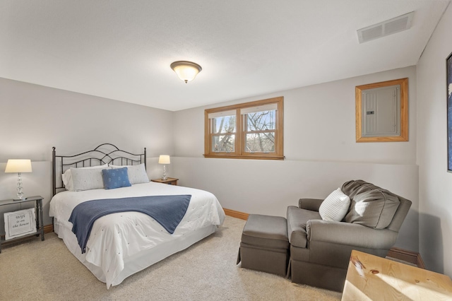 bedroom with electric panel and light carpet