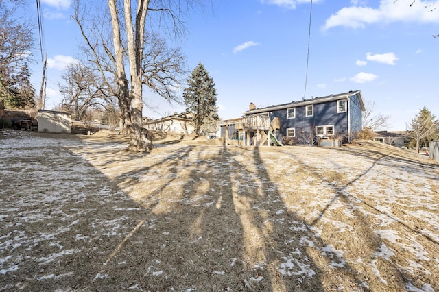 rear view of house with a shed and a deck