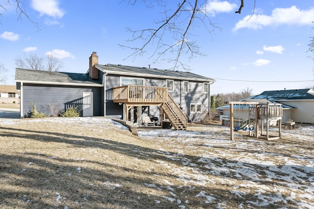 snow covered house with a wooden deck