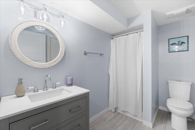 bathroom featuring vanity, hardwood / wood-style flooring, toilet, and a shower with shower curtain