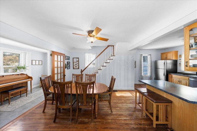 dining space with french doors, ceiling fan, and dark hardwood / wood-style floors