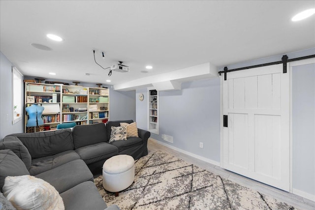 living room with wood-type flooring and a barn door