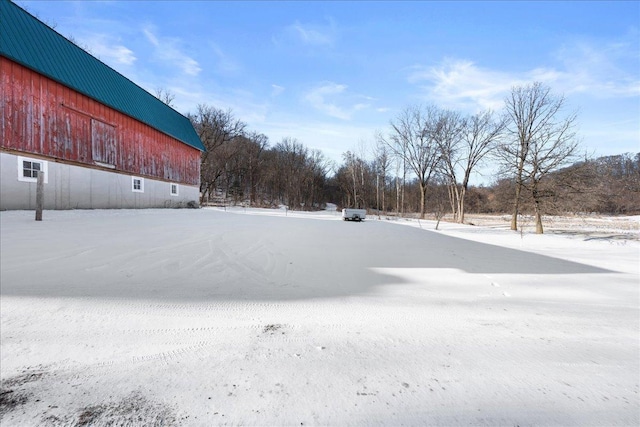 yard covered in snow featuring an outbuilding