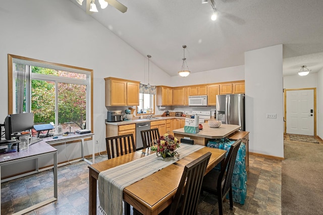 dining area with sink, high vaulted ceiling, and ceiling fan