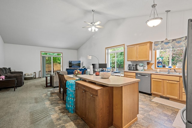 kitchen featuring a kitchen island, light brown cabinetry, decorative light fixtures, sink, and stainless steel dishwasher