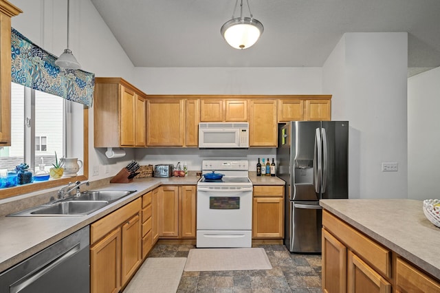 kitchen featuring sink, pendant lighting, and white appliances