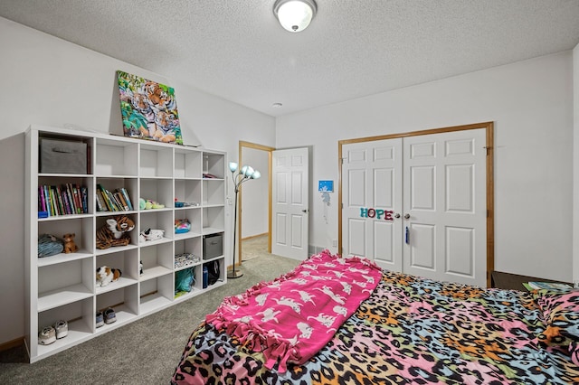 carpeted bedroom with a closet and a textured ceiling